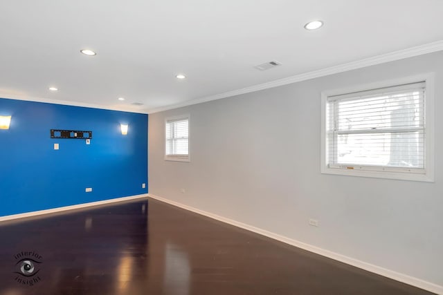 spare room with crown molding and hardwood / wood-style flooring