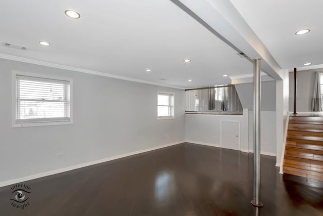 basement featuring ornamental molding and hardwood / wood-style floors