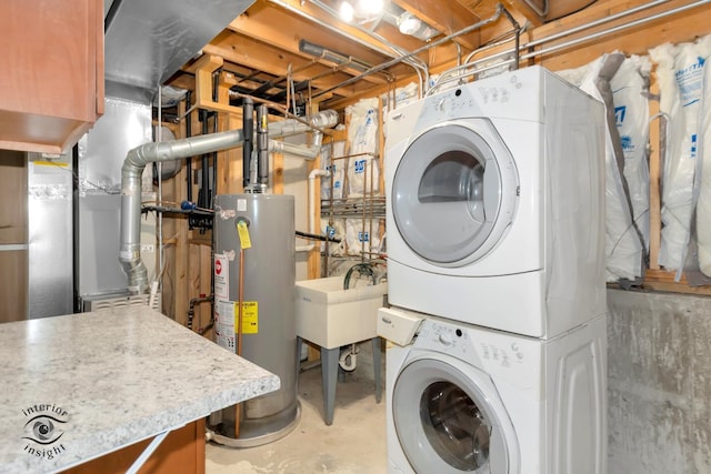 laundry room featuring stacked washing maching and dryer and water heater