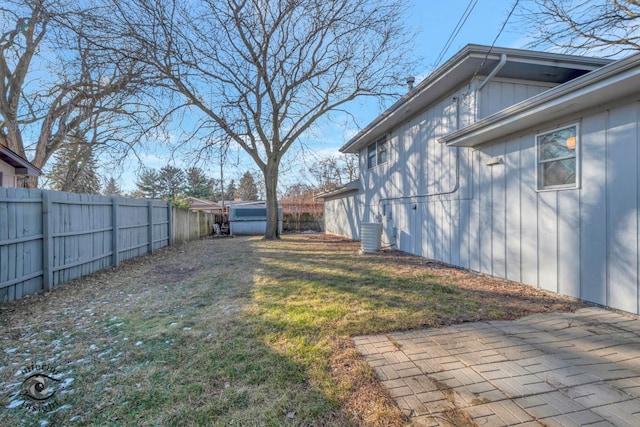 view of yard with a patio and central air condition unit