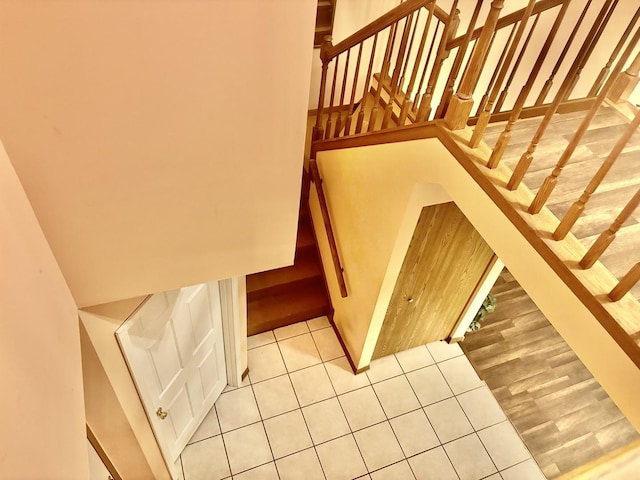 stairs featuring tile patterned flooring