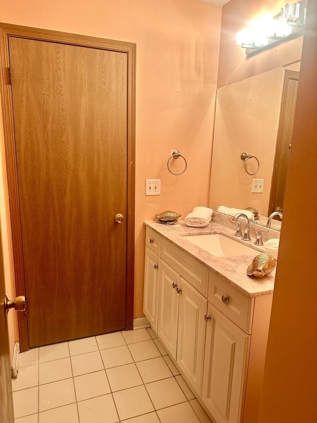 bathroom featuring tile patterned flooring and vanity