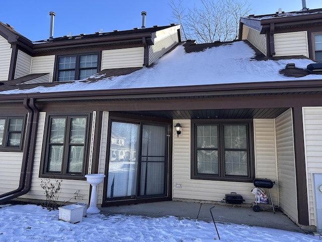 view of snow covered property entrance