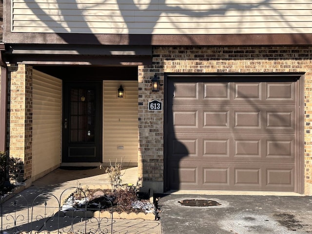 property entrance with brick siding and aphalt driveway