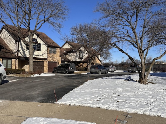 snowy yard featuring a garage