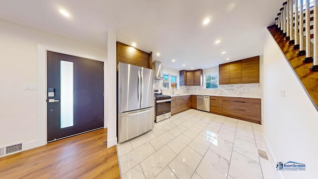 kitchen with tasteful backsplash, sink, and appliances with stainless steel finishes