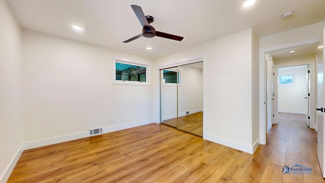 unfurnished bedroom with ceiling fan, light hardwood / wood-style floors, and a closet