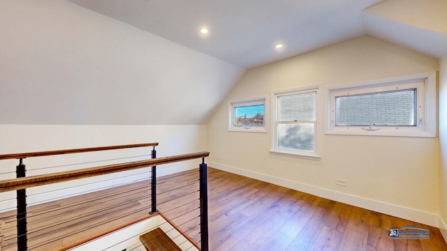 bonus room featuring wood-type flooring and vaulted ceiling