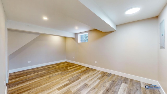 basement with hardwood / wood-style floors