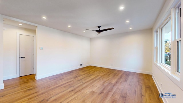 empty room featuring ceiling fan and light hardwood / wood-style flooring