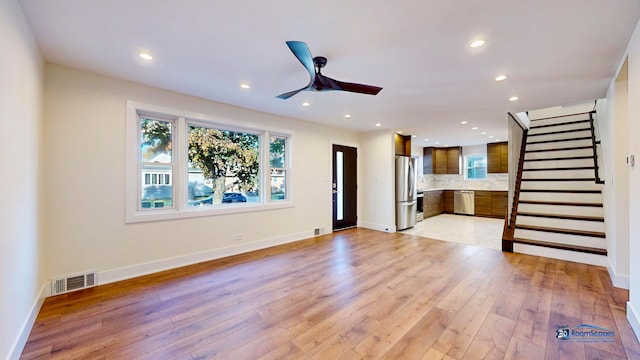 unfurnished living room featuring light hardwood / wood-style floors and ceiling fan