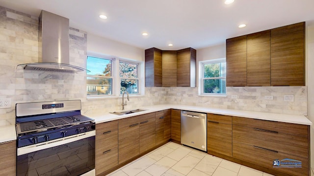 kitchen with tasteful backsplash, stainless steel appliances, sink, and wall chimney range hood