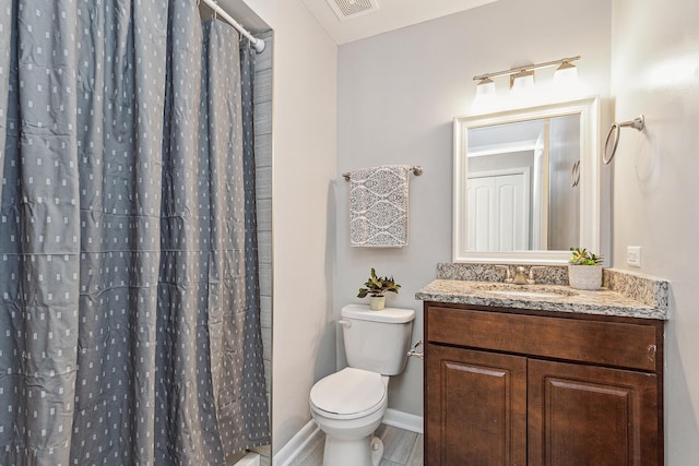 bathroom with toilet, vanity, and a shower with shower curtain