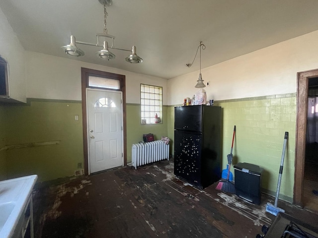 foyer entrance featuring radiator heating unit