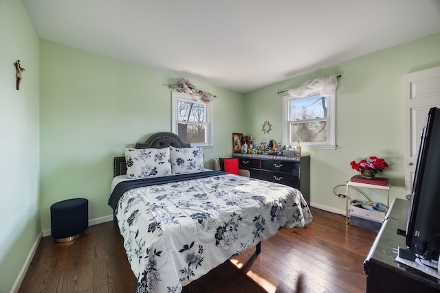 bedroom featuring multiple windows and dark hardwood / wood-style floors