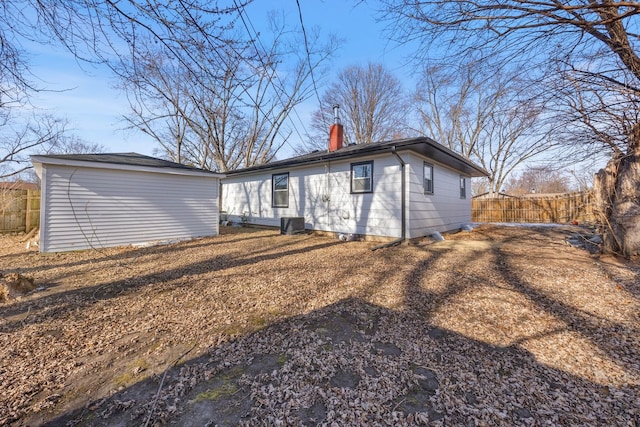 back of house with central AC unit