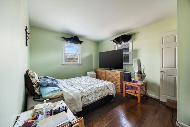 bedroom with dark hardwood / wood-style flooring