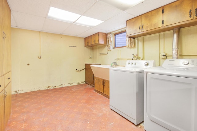 laundry area featuring cabinets, independent washer and dryer, and sink