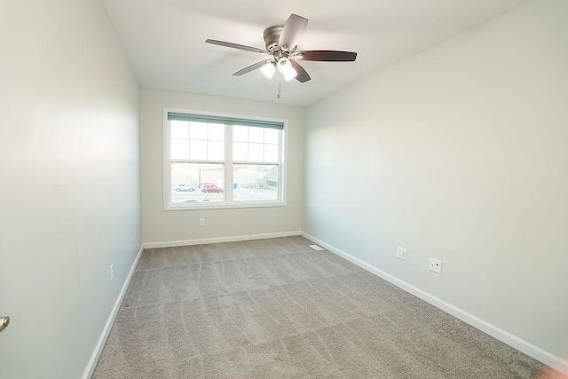 carpeted spare room with ceiling fan