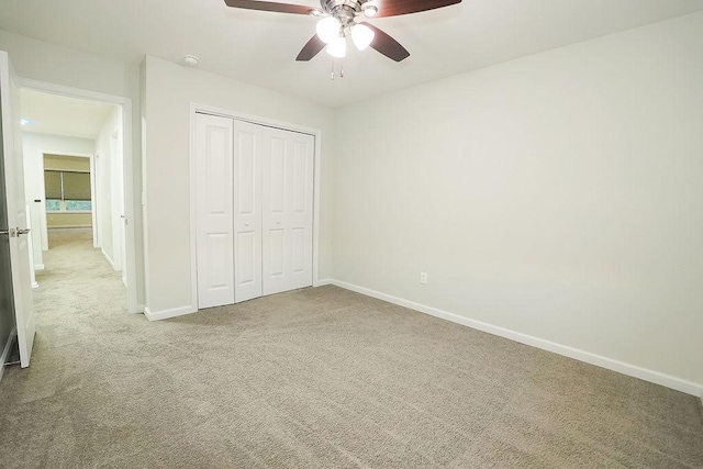 unfurnished bedroom featuring a closet, ceiling fan, and carpet flooring