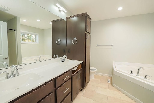 bathroom featuring vanity, toilet, tile patterned flooring, and a tub