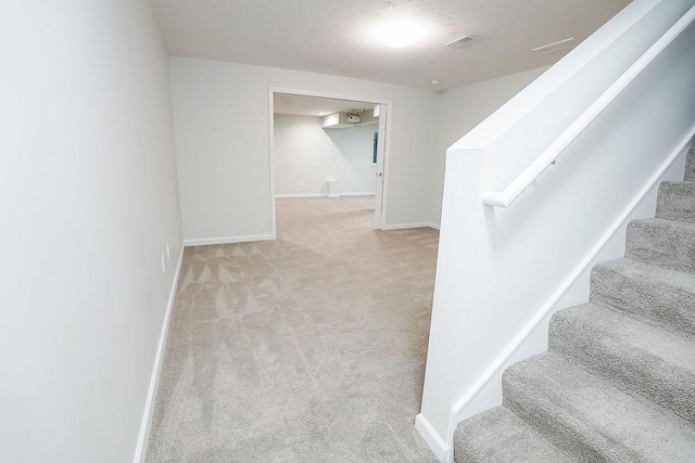 stairs featuring carpet flooring