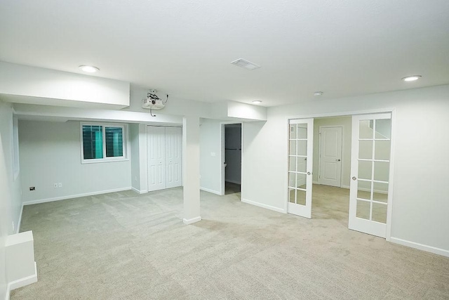 basement featuring light carpet and french doors