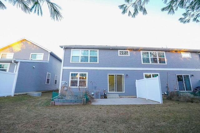 rear view of house featuring a yard and a patio area