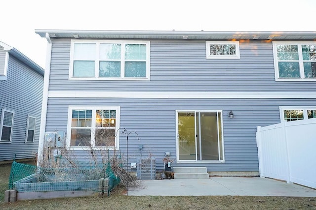 back of property featuring cooling unit and a patio