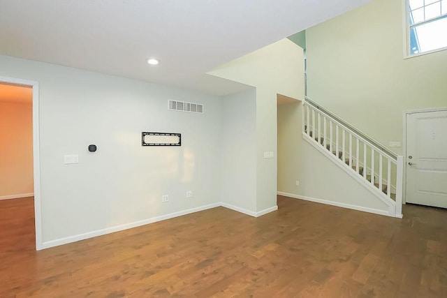 unfurnished living room featuring dark hardwood / wood-style floors