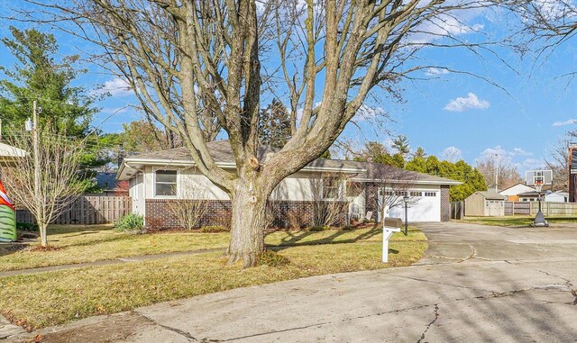 ranch-style house with a garage and a front yard