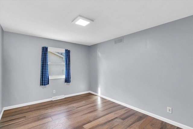 unfurnished room with hardwood / wood-style floors