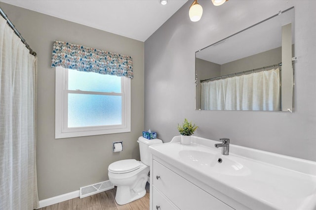 bathroom featuring hardwood / wood-style flooring, vanity, and toilet