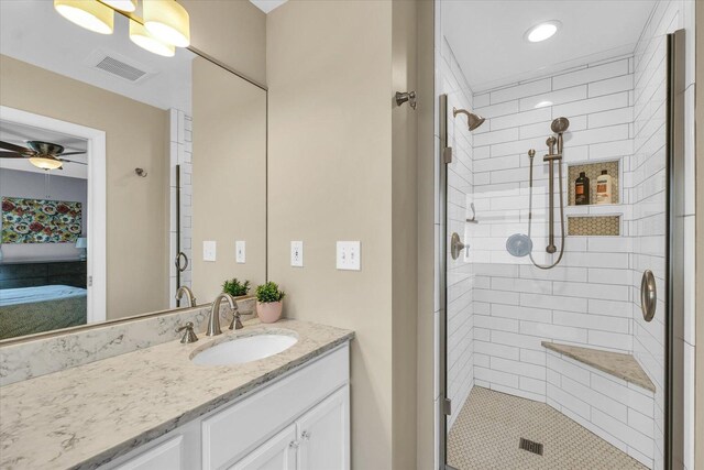 bathroom featuring vanity, ceiling fan, and a shower with shower door