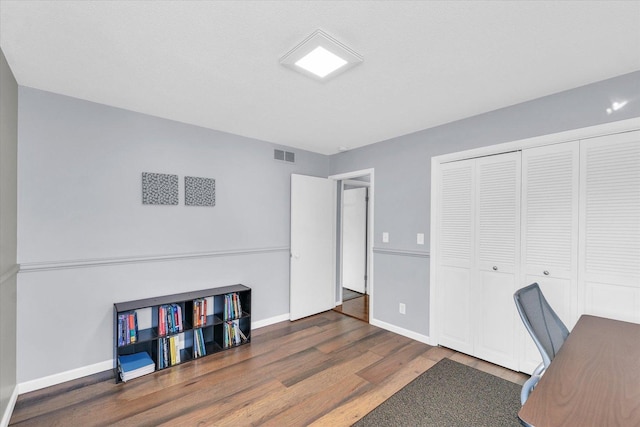 office with dark hardwood / wood-style floors