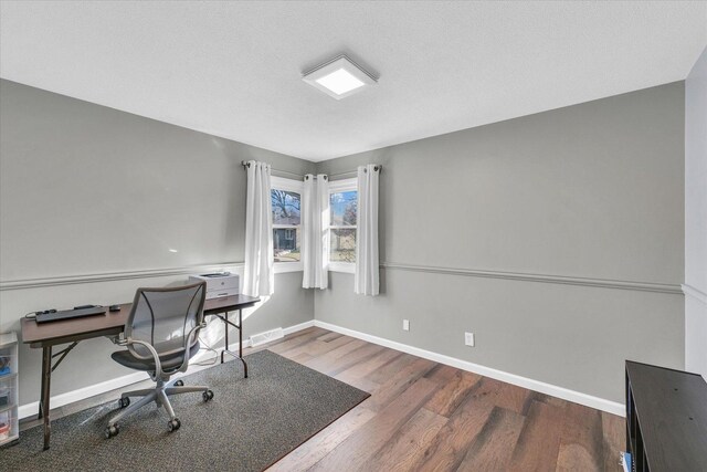 office space with hardwood / wood-style floors and a textured ceiling