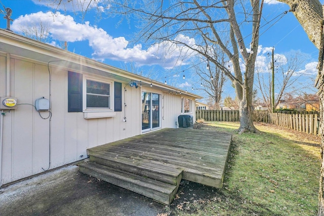 wooden terrace featuring a yard