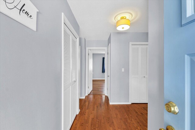 hallway with dark wood-type flooring