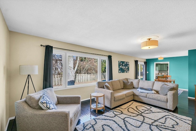 living room with hardwood / wood-style floors and a textured ceiling