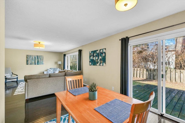 dining room with hardwood / wood-style flooring and a textured ceiling