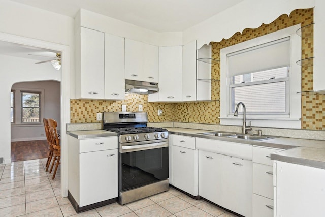 939 N Grace St, Lombard, IL 60148 - kitchen featuring white cabinetry, sink, stainless steel range with gas stovetop, and backsplash