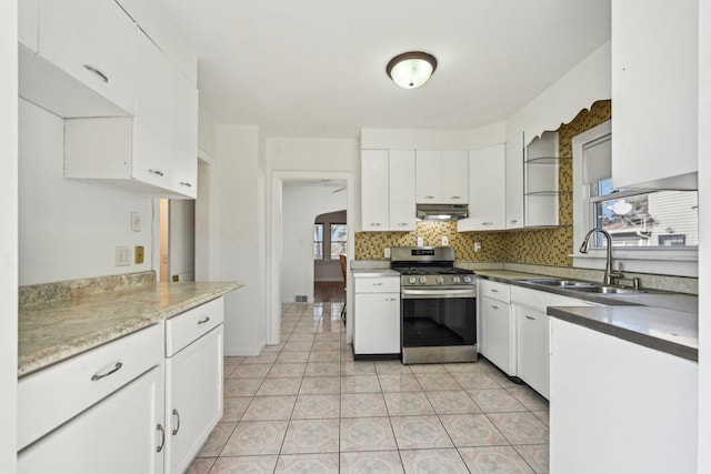 939 N Grace St, Lombard, IL 60148 - kitchen featuring stainless steel range with gas cooktop, white cabinetry, sink, decorative backsplash, and light tile patterned floors