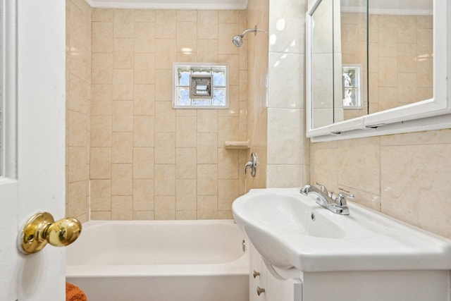 939 N Grace St, Lombard, IL 60148 - bathroom featuring tasteful backsplash, crown molding, tile walls, vanity, and tiled shower / bath combo