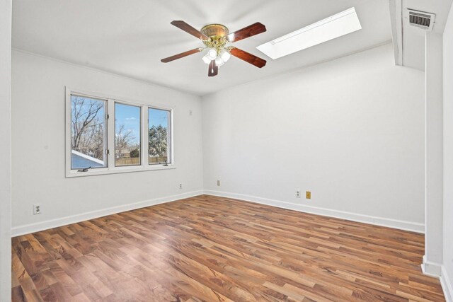 939 N Grace St, Lombard, IL 60148 - unfurnished room with wood-type flooring, ceiling fan, and a skylight