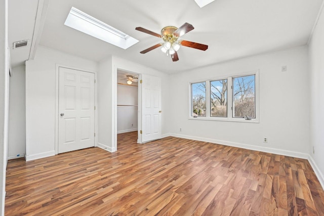 939 N Grace St, Lombard, IL 60148 - unfurnished bedroom featuring ceiling fan, lofted ceiling with skylight, hardwood / wood-style floors, and a closet