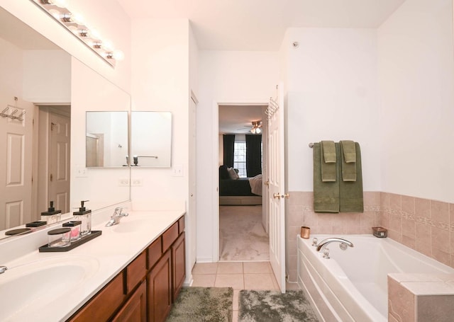 bathroom featuring ceiling fan, tile patterned floors, a bathing tub, and vanity