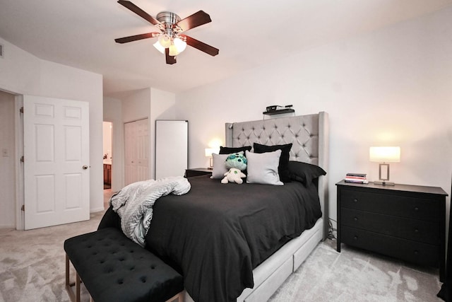 carpeted bedroom with ceiling fan and a closet