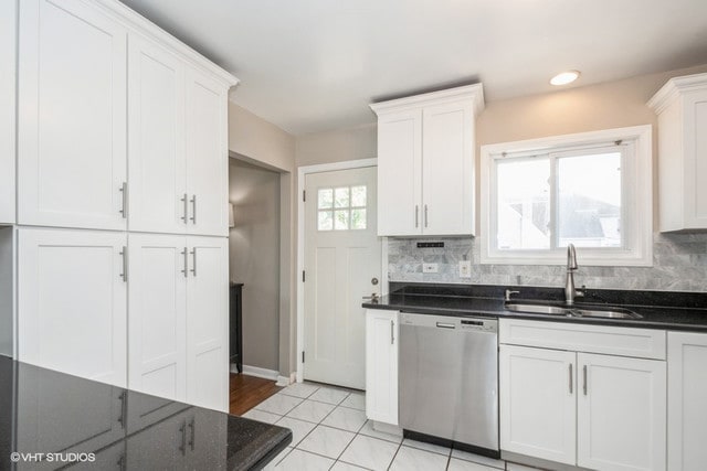 kitchen with white cabinetry, sink, tasteful backsplash, and stainless steel dishwasher