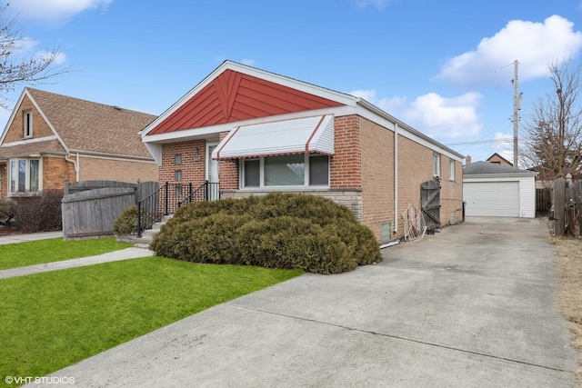 view of front of property with an outbuilding, a garage, and a front lawn