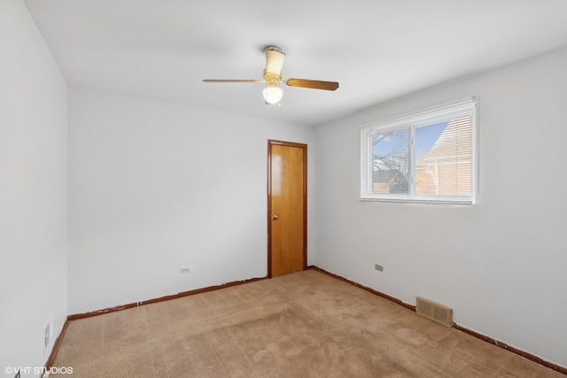 unfurnished room with ceiling fan and light colored carpet